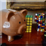 D42. Football piggy bank and Rubiks cubes. 